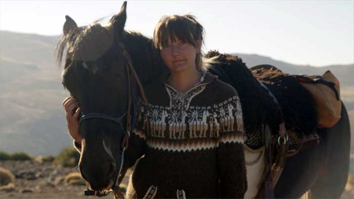 Close-up portrait of Stephanie with her horse.